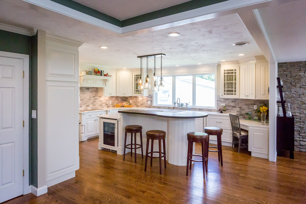 Mid-sized transitional u-shaped medium tone wood floor eat-in kitchen photo in Boston with raised-panel cabinets, white cabinets, quartz countertops, gray backsplash, stone tile backsplash, paneled appliances, an island and a farmhouse sink
