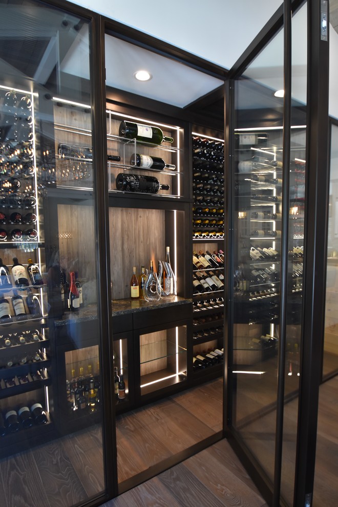 Large trendy medium tone wood floor wine cellar photo in Orange County