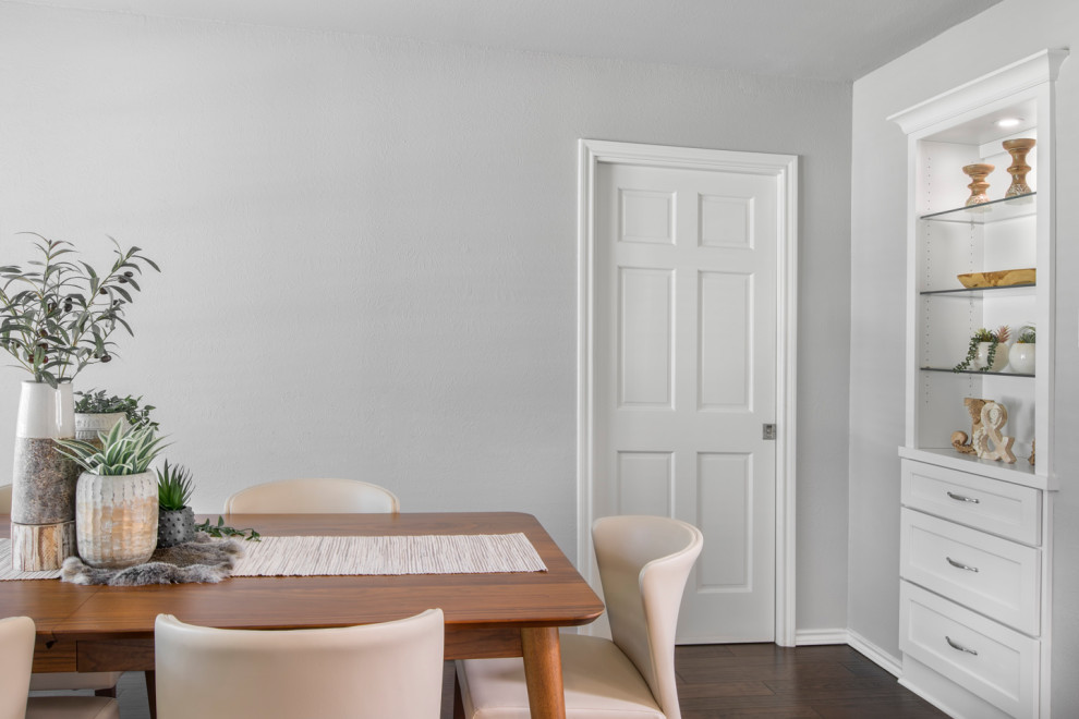 Example of a mid-sized transitional brown floor kitchen/dining room combo design with gray walls and no fireplace