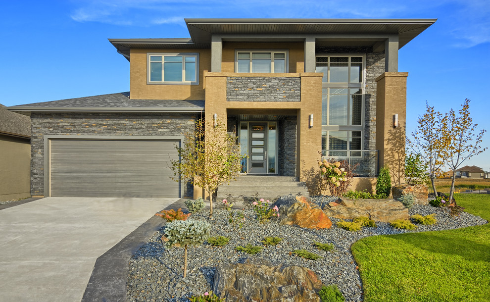 Design ideas for a large contemporary two-storey exterior in Other with stone veneer.