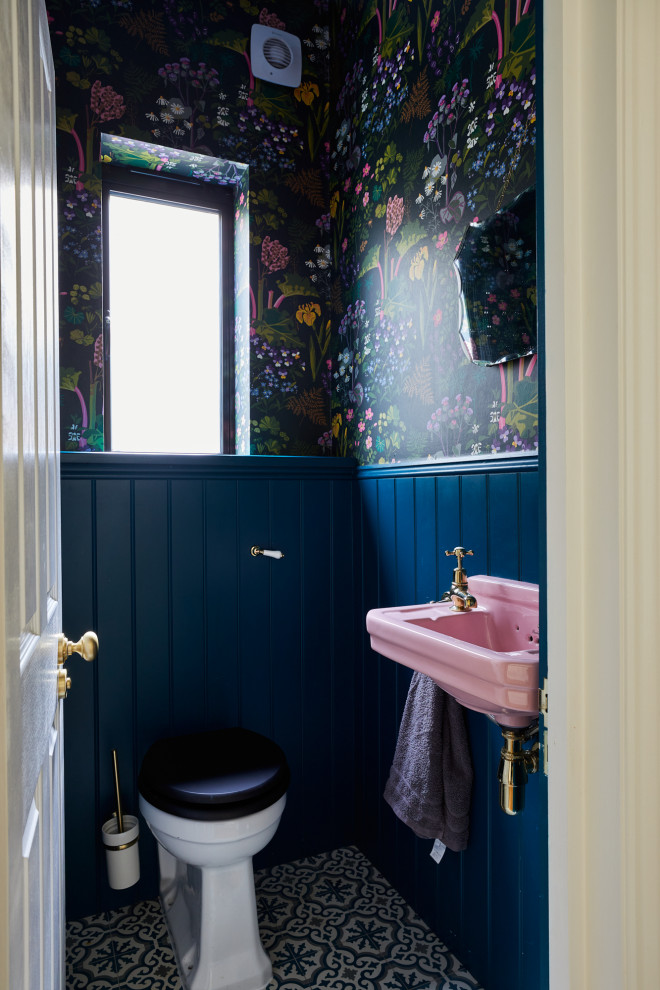 Design ideas for a traditional cloakroom in London with a one-piece toilet, multi-coloured walls, ceramic flooring, a feature wall, a floating vanity unit and wallpapered walls.