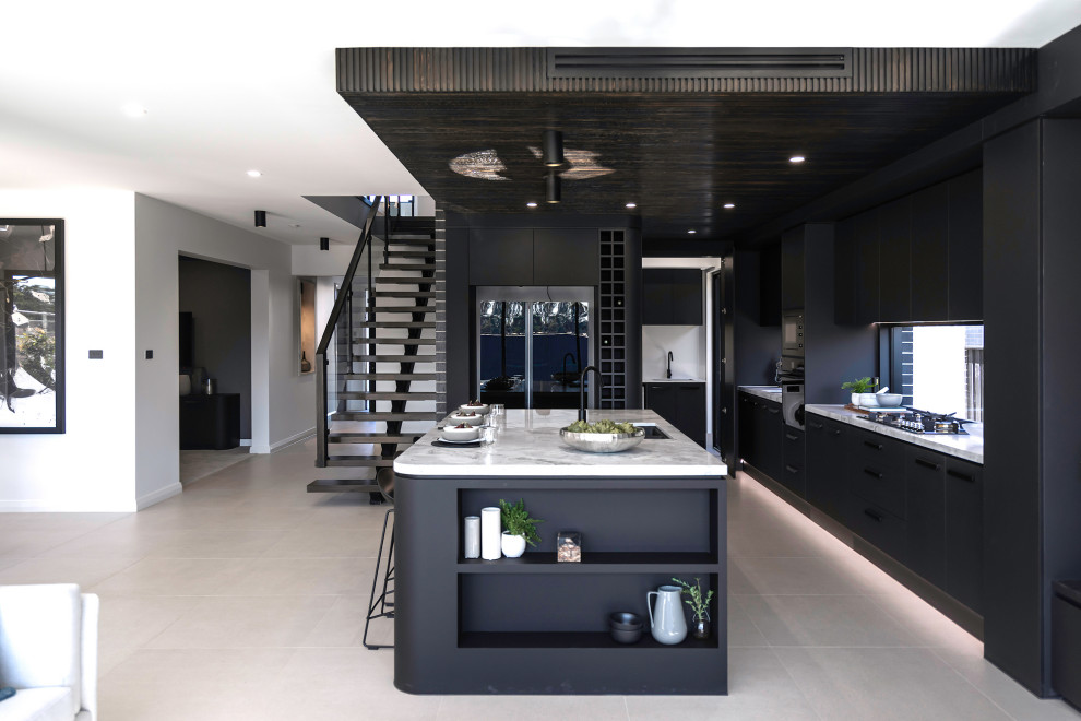 Inspiration for a contemporary l-shaped kitchen in Sydney with flat-panel cabinets, black cabinets, black appliances, with island, grey floor, white benchtop and wood.