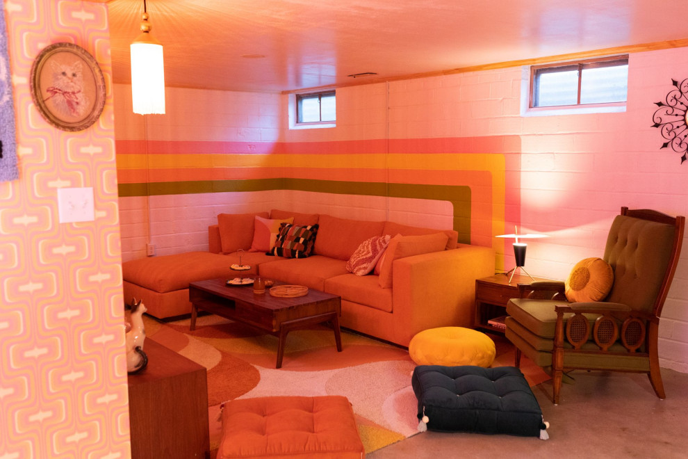 Large midcentury fully buried basement in Other with pink walls, concrete floors and brick walls.