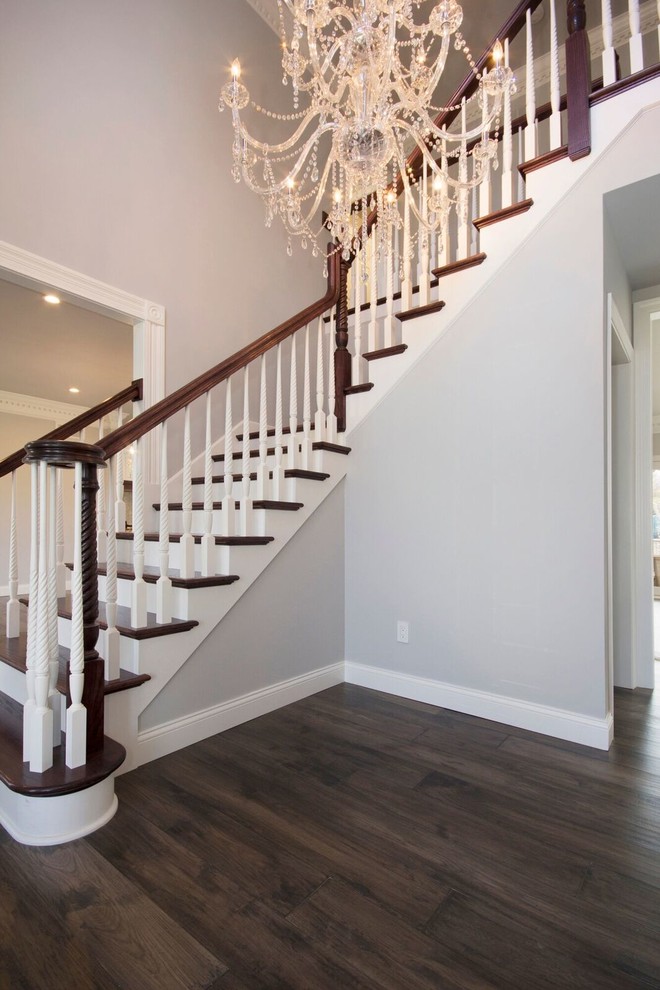 Inspiration for a mid-sized transitional medium tone wood floor and brown floor single front door remodel in St Louis with gray walls and a white front door