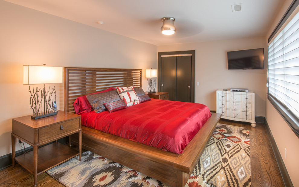 Example of a mid-sized transitional guest medium tone wood floor and brown floor bedroom design with white walls and no fireplace