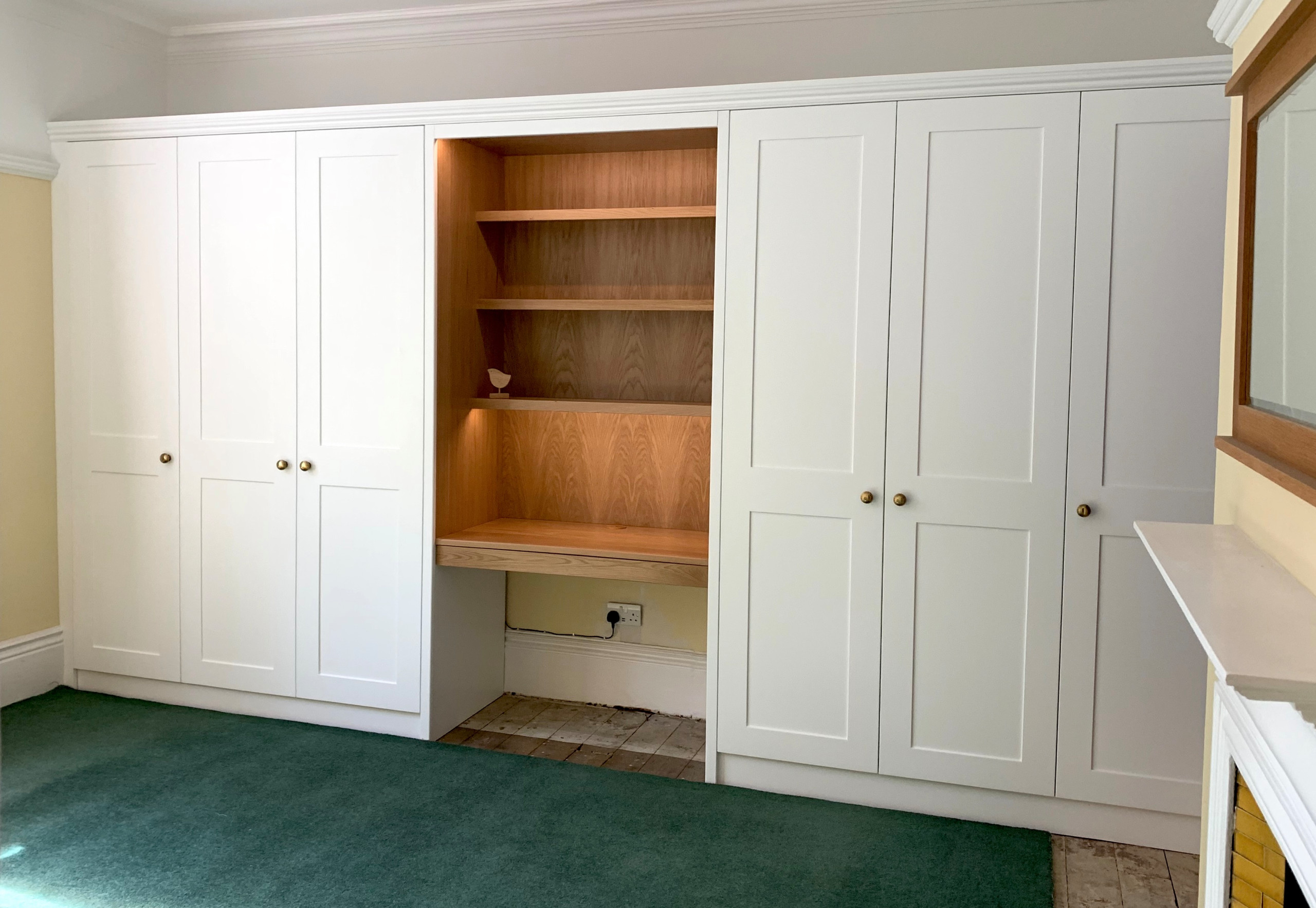 Wardrobes with white spray painted shaker doors and oak desk area