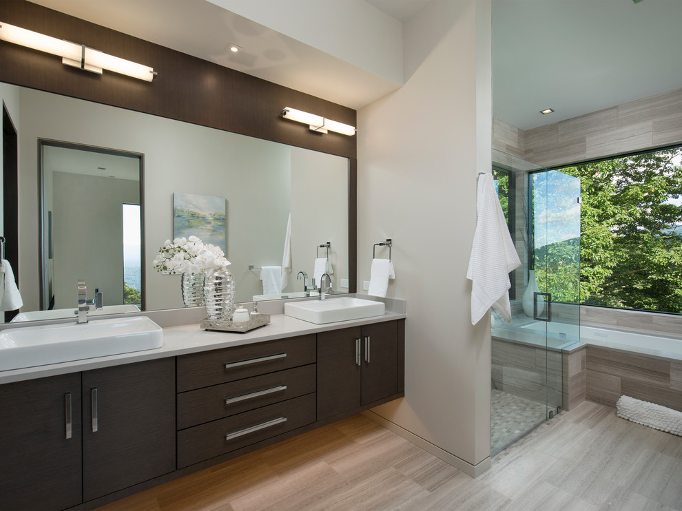 Photo of a large contemporary master bathroom in Other with flat-panel cabinets, dark wood cabinets, beige tile, stone tile, ceramic floors, engineered quartz benchtops, an undermount tub, a curbless shower, beige walls, a vessel sink and a hinged shower door.