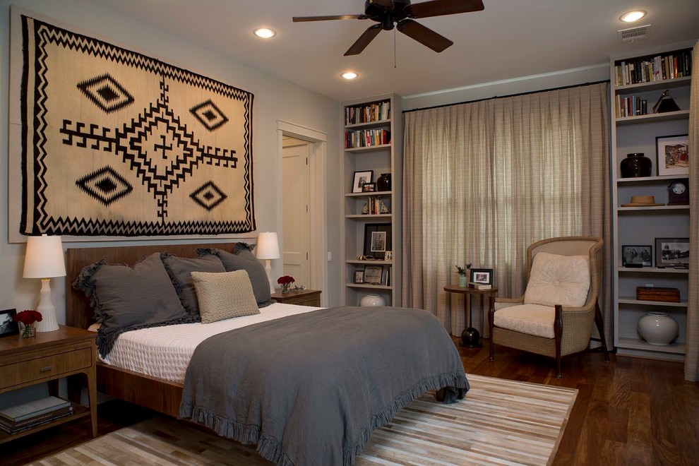 Photo of a large transitional master bedroom in Austin with grey walls and dark hardwood floors.