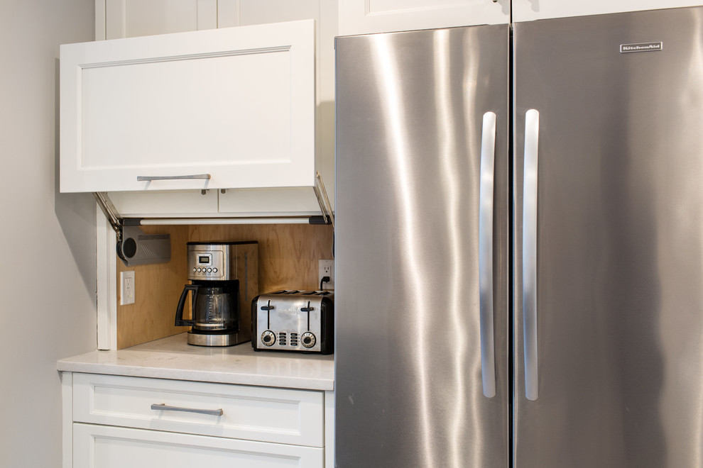 Open concept kitchen - large transitional ceramic tile open concept kitchen idea in New York with an undermount sink, shaker cabinets, white cabinets, quartz countertops, gray backsplash, ceramic backsplash, stainless steel appliances and an island