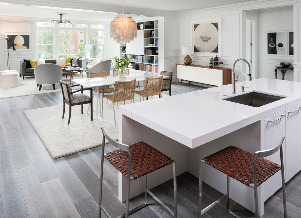 Mid-sized contemporary l-shaped eat-in kitchen in Minneapolis with flat-panel cabinets, panelled appliances, medium hardwood floors, with island, grey floor, an undermount sink, black cabinets and quartzite benchtops.