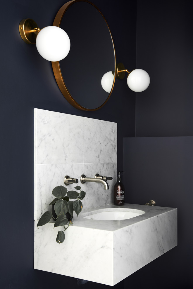 Small contemporary powder room in Sydney with blue walls, marble floors, an undermount sink and marble benchtops.