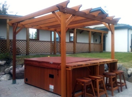Design ideas for a backyard patio in Calgary with a water feature, gravel and a gazebo/cabana.
