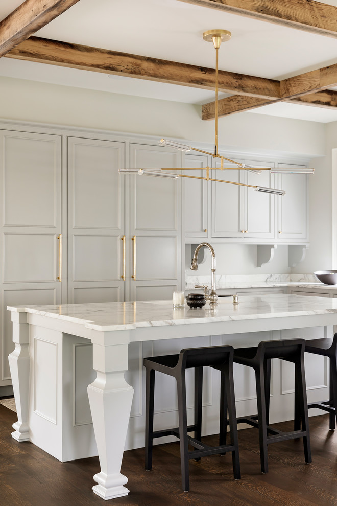 Mid-sized transitional l-shaped dark wood floor and brown floor kitchen photo in Minneapolis with recessed-panel cabinets, gray cabinets, marble countertops, an island and white countertops