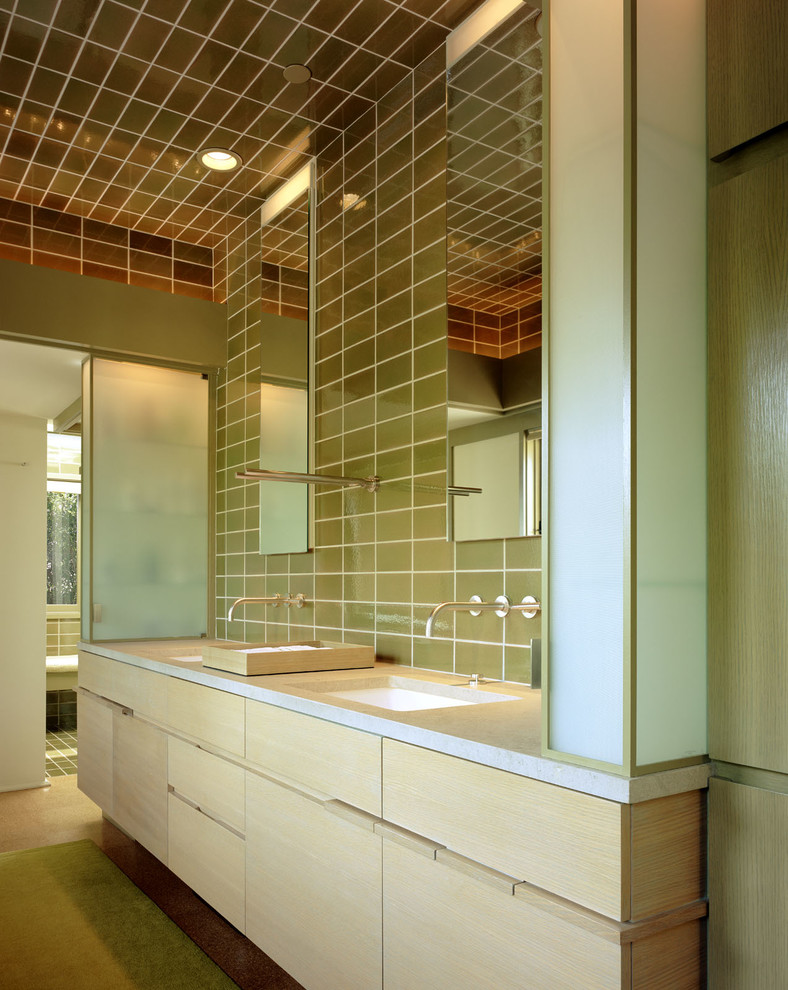 This is an example of a modern bathroom in Los Angeles with flat-panel cabinets, light wood cabinets and green tile.