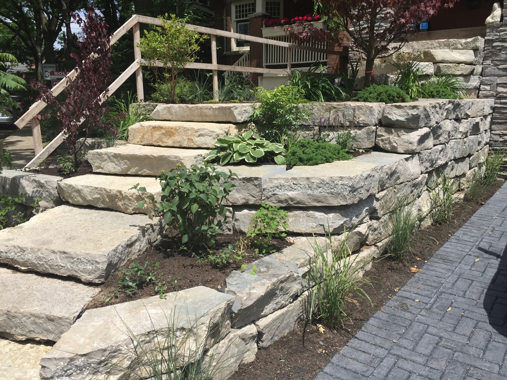 Design ideas for a mid-sized rustic partial sun front yard stone driveway in Orange County for summer.