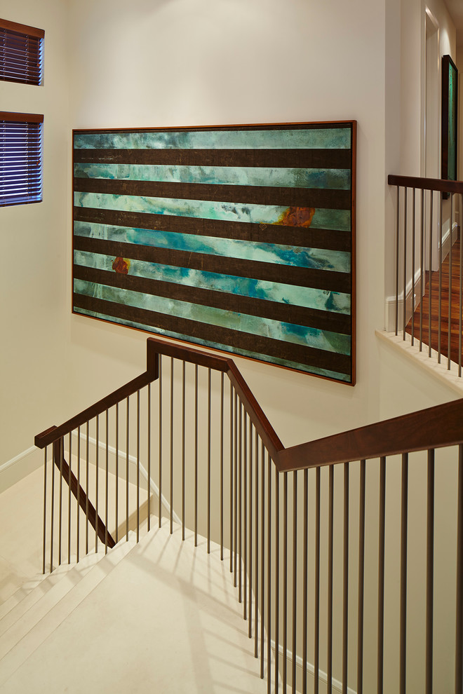 Inspiration for a large contemporary wood u-shaped staircase in Miami with tile risers.