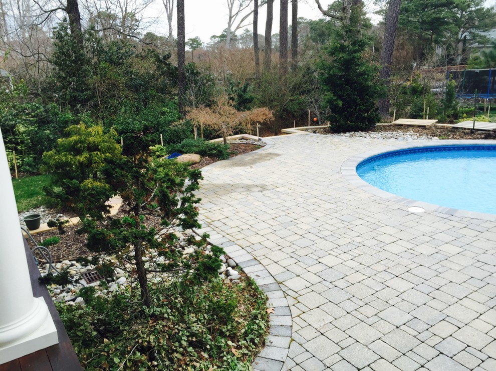Pool fountain - mid-sized backyard stone and custom-shaped natural pool fountain idea