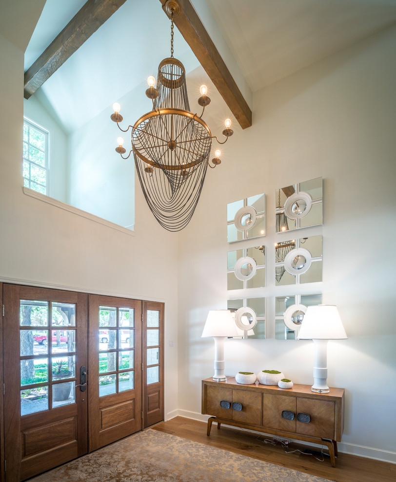 Inspiration for a transitional medium tone wood floor front door remodel with white walls and a medium wood front door