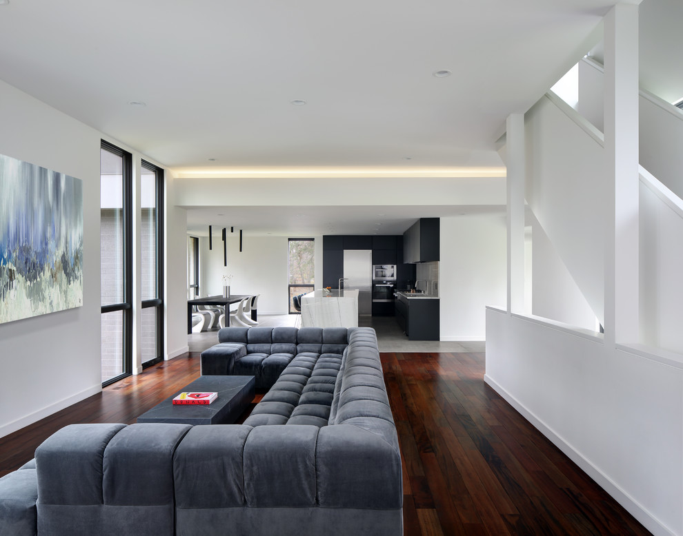 Inspiration for a modern living room in Milwaukee with white walls, medium hardwood floors and brown floor.