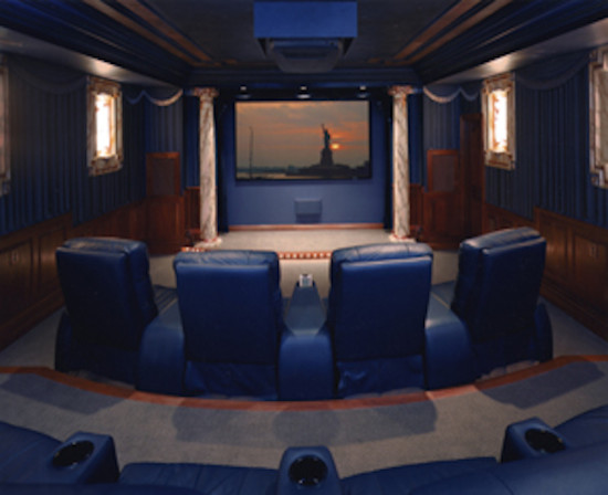 Enclosed carpeted home theater photo in Cincinnati with blue walls and a projector screen