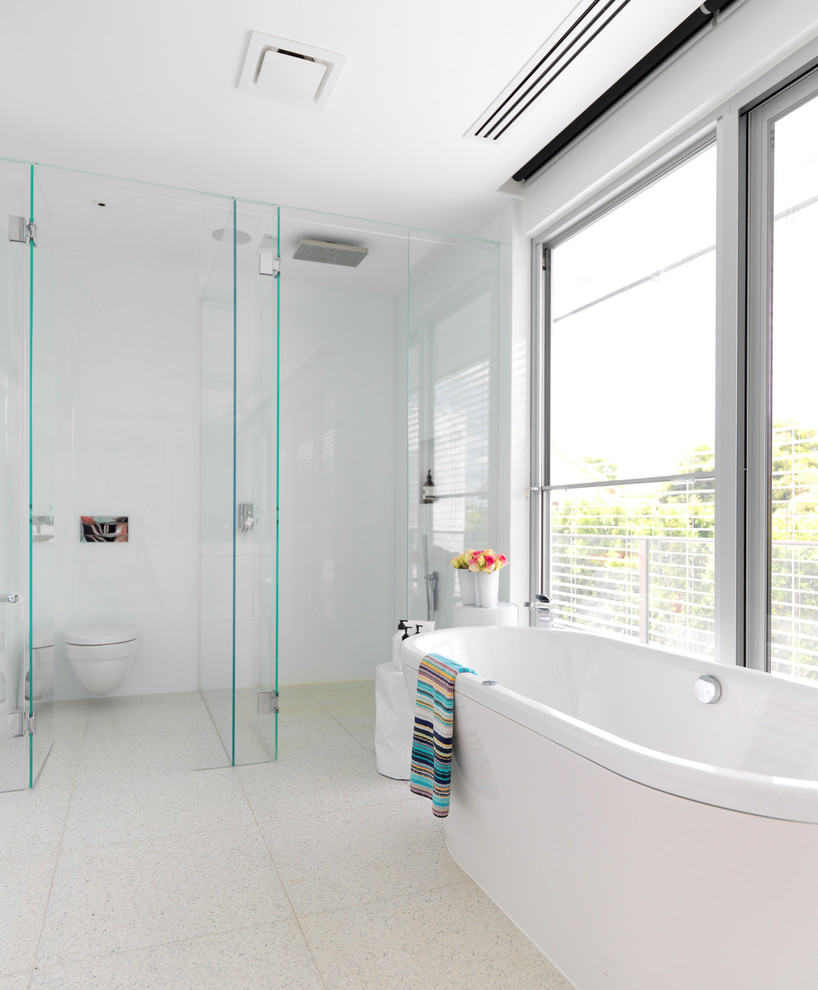 Contemporary bathroom in Melbourne with a curbless shower, a wall-mount toilet and an enclosed toilet.