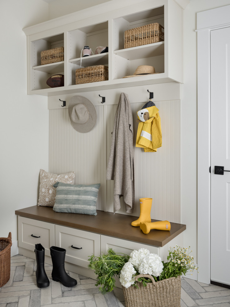 Mid-sized transitional brick floor and beige floor mudroom photo in Seattle with beige walls and a white front door