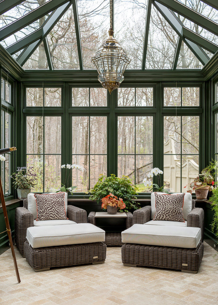 This is an example of a mid-sized traditional sunroom in Other with limestone floors, beige floor and a glass ceiling.