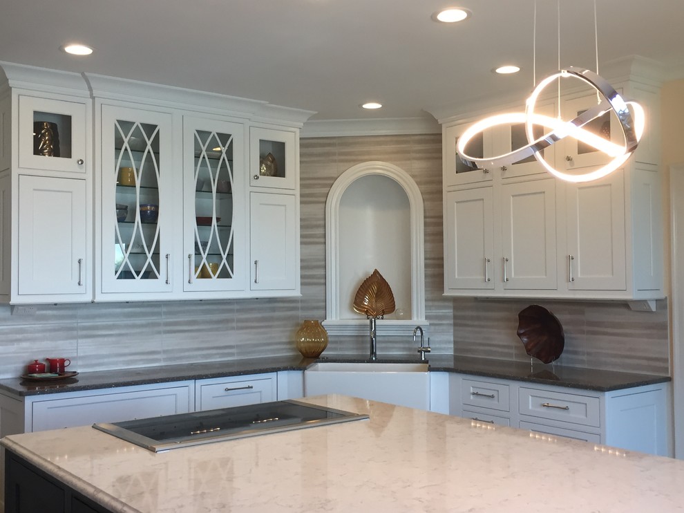 Inspiration for a large transitional ceramic tile and multicolored floor kitchen remodel with a farmhouse sink, beaded inset cabinets, white cabinets, quartz countertops, metallic backsplash, ceramic backsplash, stainless steel appliances and an island