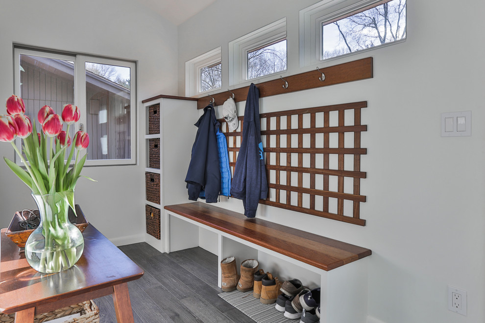 Design ideas for a mid-sized contemporary mudroom in Boston with white walls, porcelain floors, a single front door and grey floor.