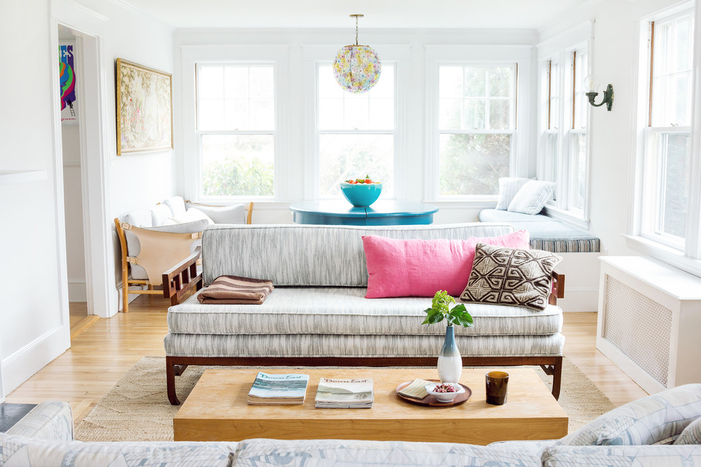 Photo of a beach style living room in Portland Maine with white walls.