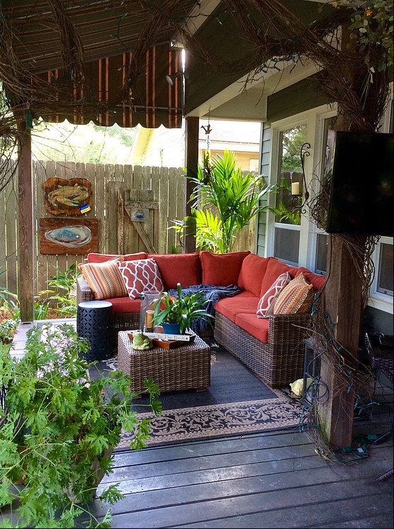 Photo of a mid-sized traditional backyard patio in New Orleans with decking and an awning.