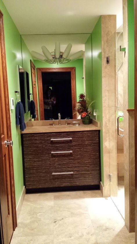 Home design - small eclectic 3/4 beige tile and stone tile travertine floor home design idea with brown cabinets, limestone countertops, a wall-mount toilet and green walls