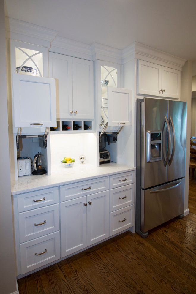Inspiration for a huge transitional medium tone wood floor open concept kitchen remodel with an undermount sink, shaker cabinets, white cabinets, marble countertops, white backsplash, ceramic backsplash, stainless steel appliances and two islands