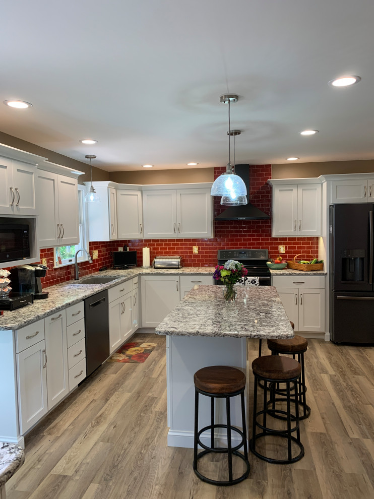 Kitchen - transitional kitchen idea with red backsplash