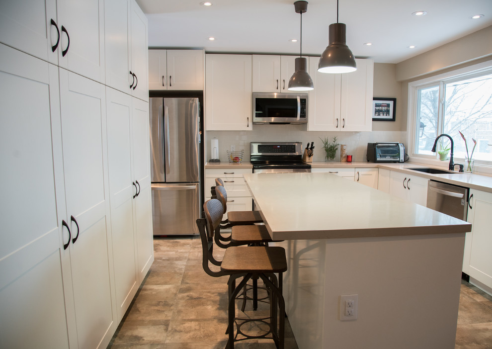 Kitchen - transitional kitchen idea in Toronto with white cabinets and white backsplash