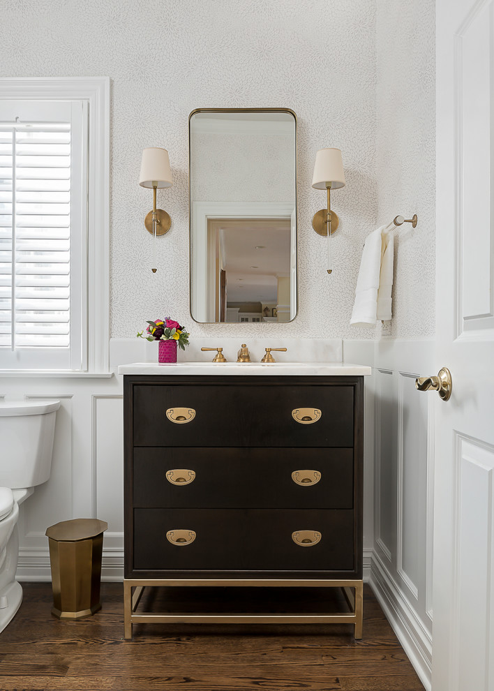 Inspiration for a small transitional powder room in Chicago with flat-panel cabinets, dark wood cabinets, medium hardwood floors, an undermount sink, marble benchtops and brown floor.
