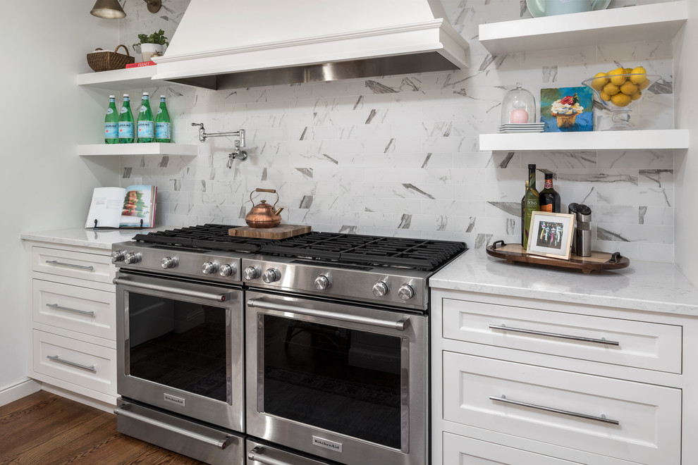 Eat-in kitchen - mid-sized transitional u-shaped medium tone wood floor and brown floor eat-in kitchen idea in St Louis with a single-bowl sink, flat-panel cabinets, white cabinets, quartz countertops, ceramic backsplash, stainless steel appliances and an island
