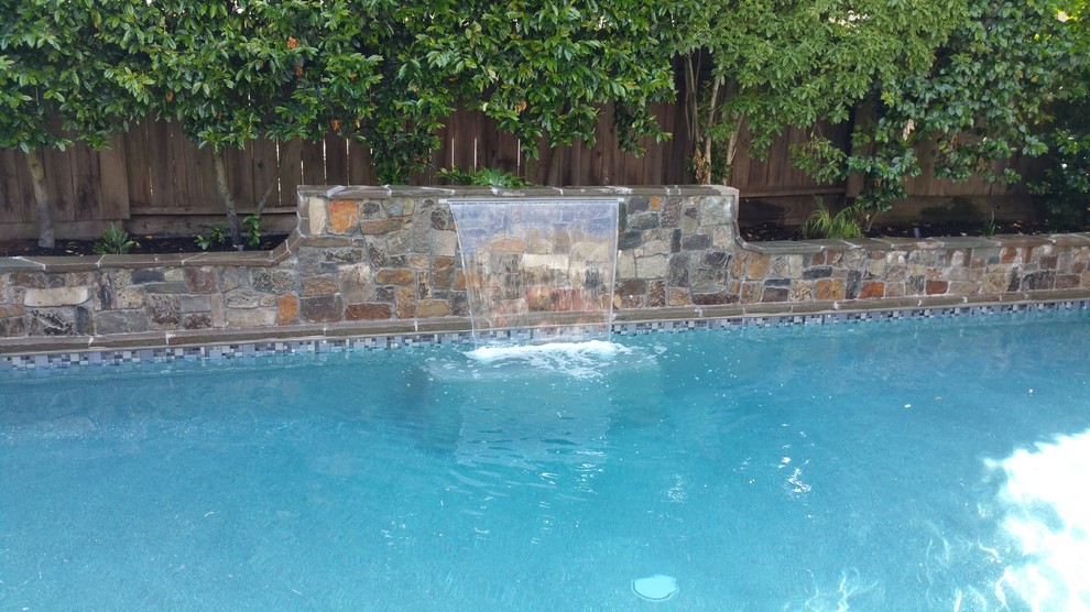 Mid-sized transitional backyard stone and rectangular lap pool fountain photo in San Francisco
