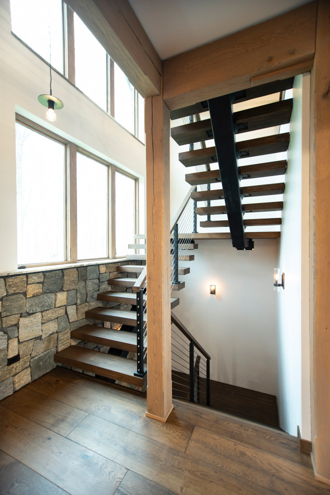 Staircase - rustic wooden floating open, mixed material railing and brick wall staircase idea