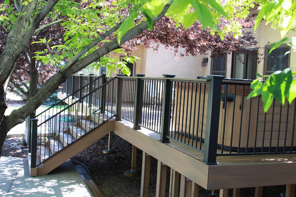 Example of a large transitional backyard deck design in Denver with no cover