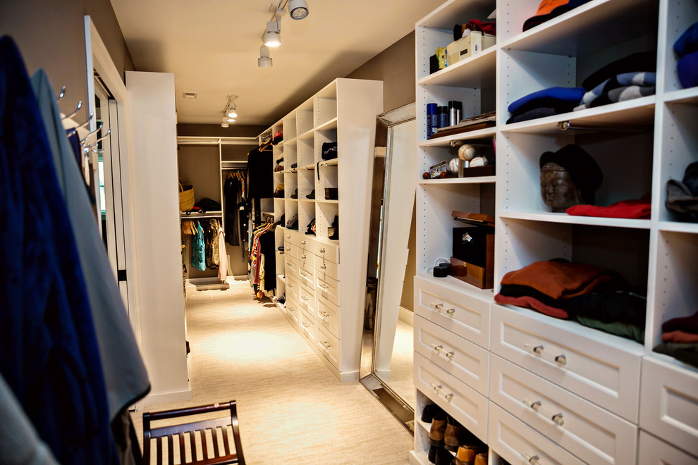 Photo of a large transitional gender-neutral walk-in wardrobe in Chicago with beaded inset cabinets, white cabinets and carpet.
