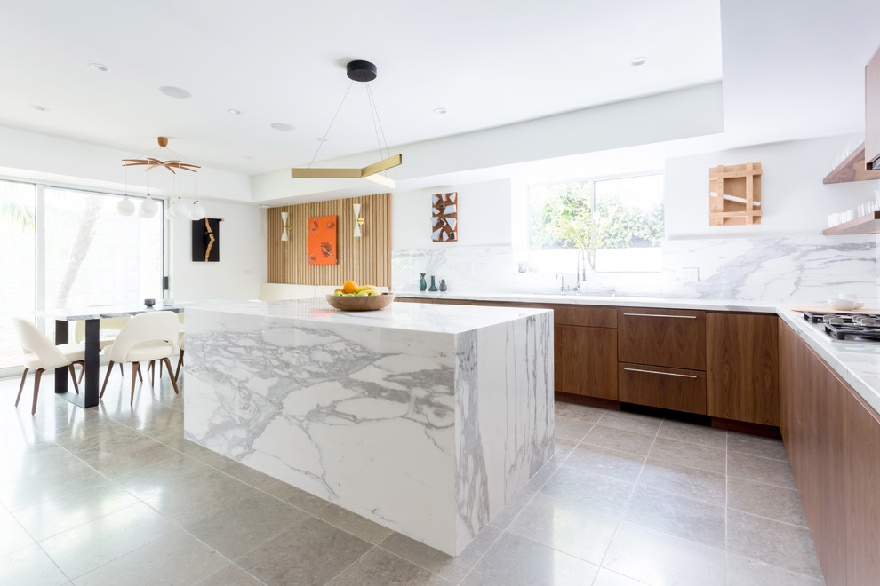 Photo of a large contemporary l-shaped eat-in kitchen in Los Angeles with flat-panel cabinets, brown cabinets, marble benchtops, white splashback, marble splashback, with island, an undermount sink, panelled appliances, ceramic floors and grey floor.