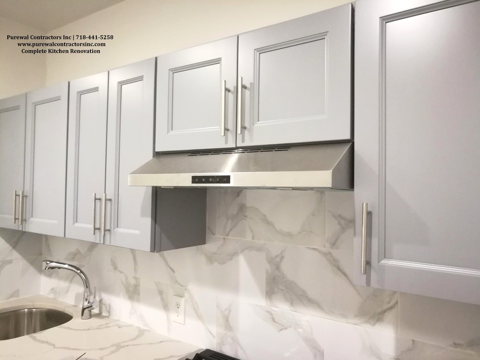 Inspiration for a small modern galley separate kitchen in New York with an undermount sink, raised-panel cabinets, grey cabinets, quartz benchtops, white splashback, marble splashback, stainless steel appliances, ceramic floors, white floor and white benchtop.
