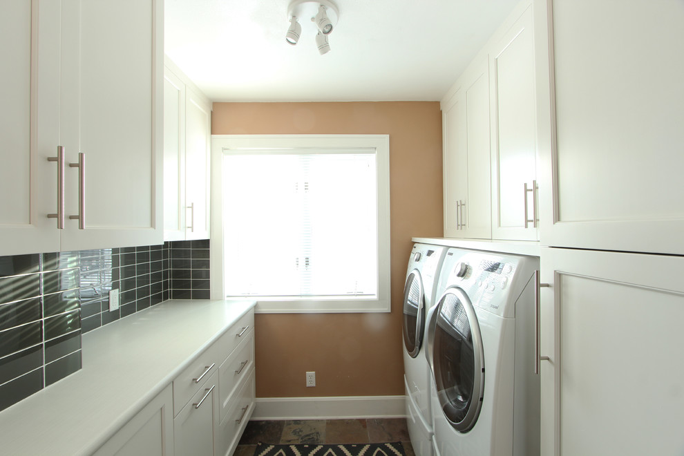 Inspiration for a small transitional galley dedicated laundry room in Other with recessed-panel cabinets, white cabinets, laminate benchtops, beige walls, slate floors, a side-by-side washer and dryer and multi-coloured floor.