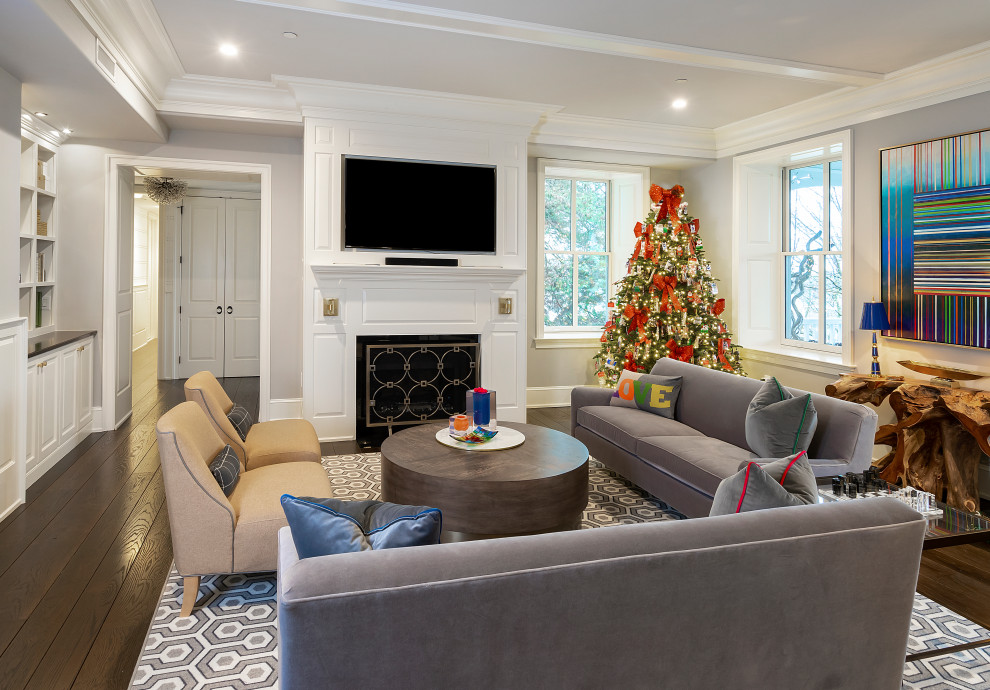 Inspiration for a transitional dark wood floor, brown floor, coffered ceiling and wall paneling living room remodel in Other with gray walls, a standard fireplace, a wood fireplace surround and a wall-mounted tv