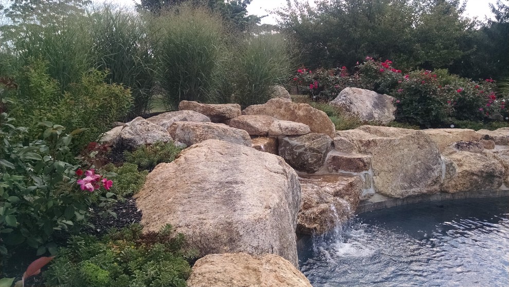 Pool - rustic backyard custom-shaped pool idea in New York