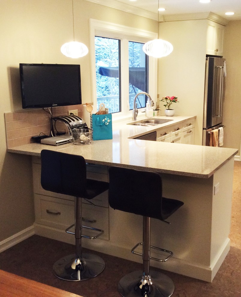 Example of a transitional cork floor kitchen design in Edmonton with white cabinets, quartzite countertops, gray backsplash, ceramic backsplash and stainless steel appliances