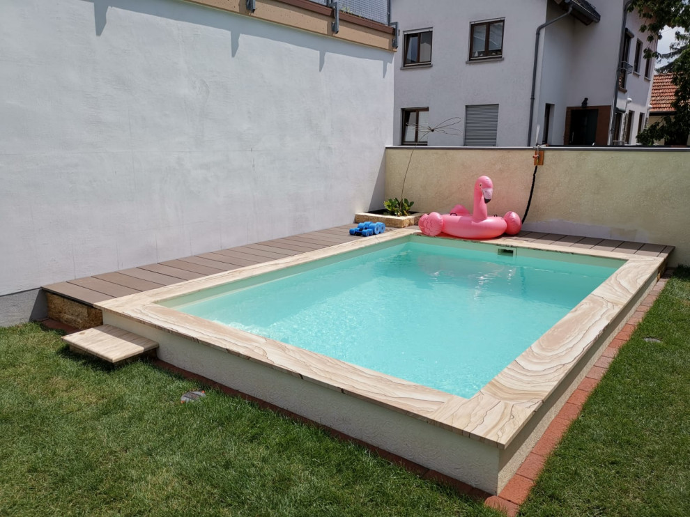 This is an example of a small front yard rectangular pool in Frankfurt with natural stone pavers.