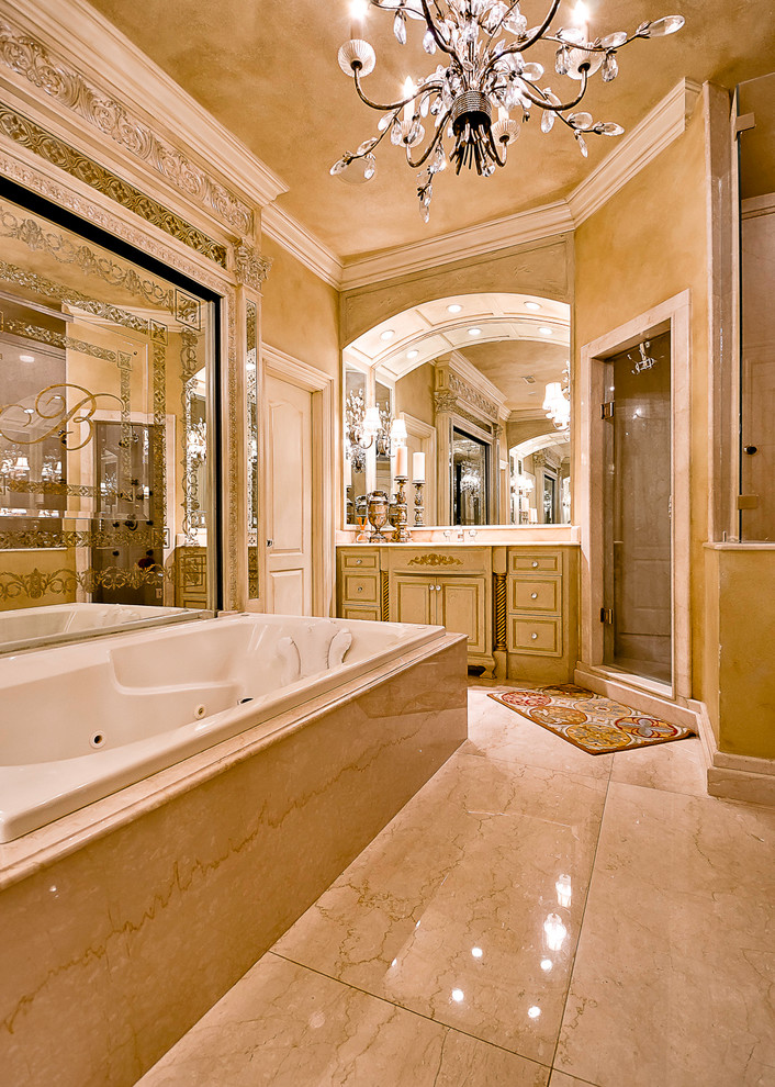 Traditional master bathroom in Little Rock with a drop-in tub and marble floors.
