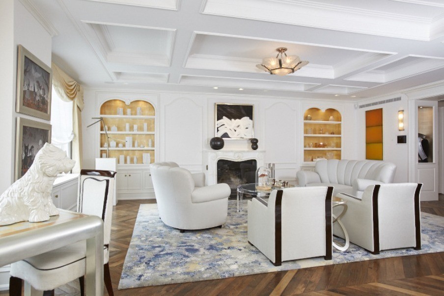 This is an example of a contemporary formal enclosed living room in New York with white walls, medium hardwood floors, a standard fireplace and no tv.